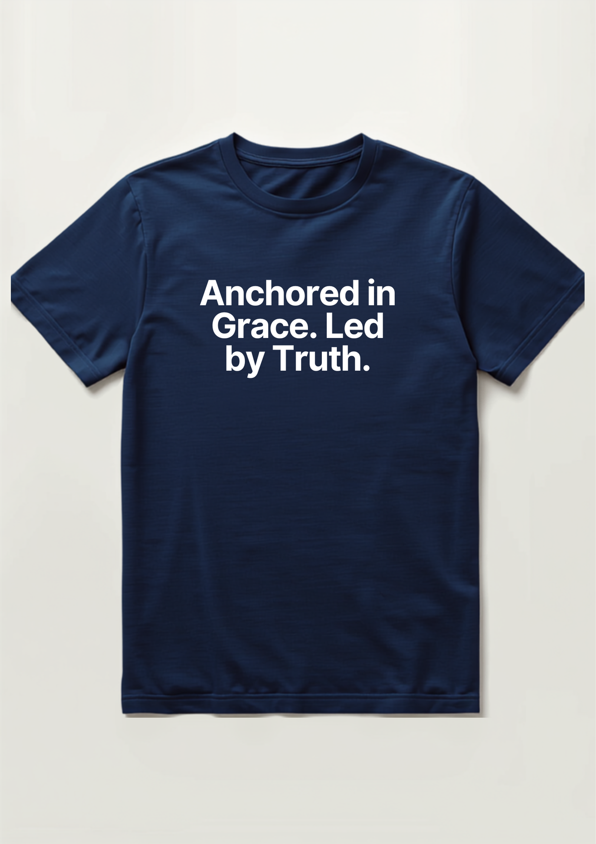 Anchored in Grace Tee in navy, flat lay, reading Anchored in Grace. Led by Truth. in white text