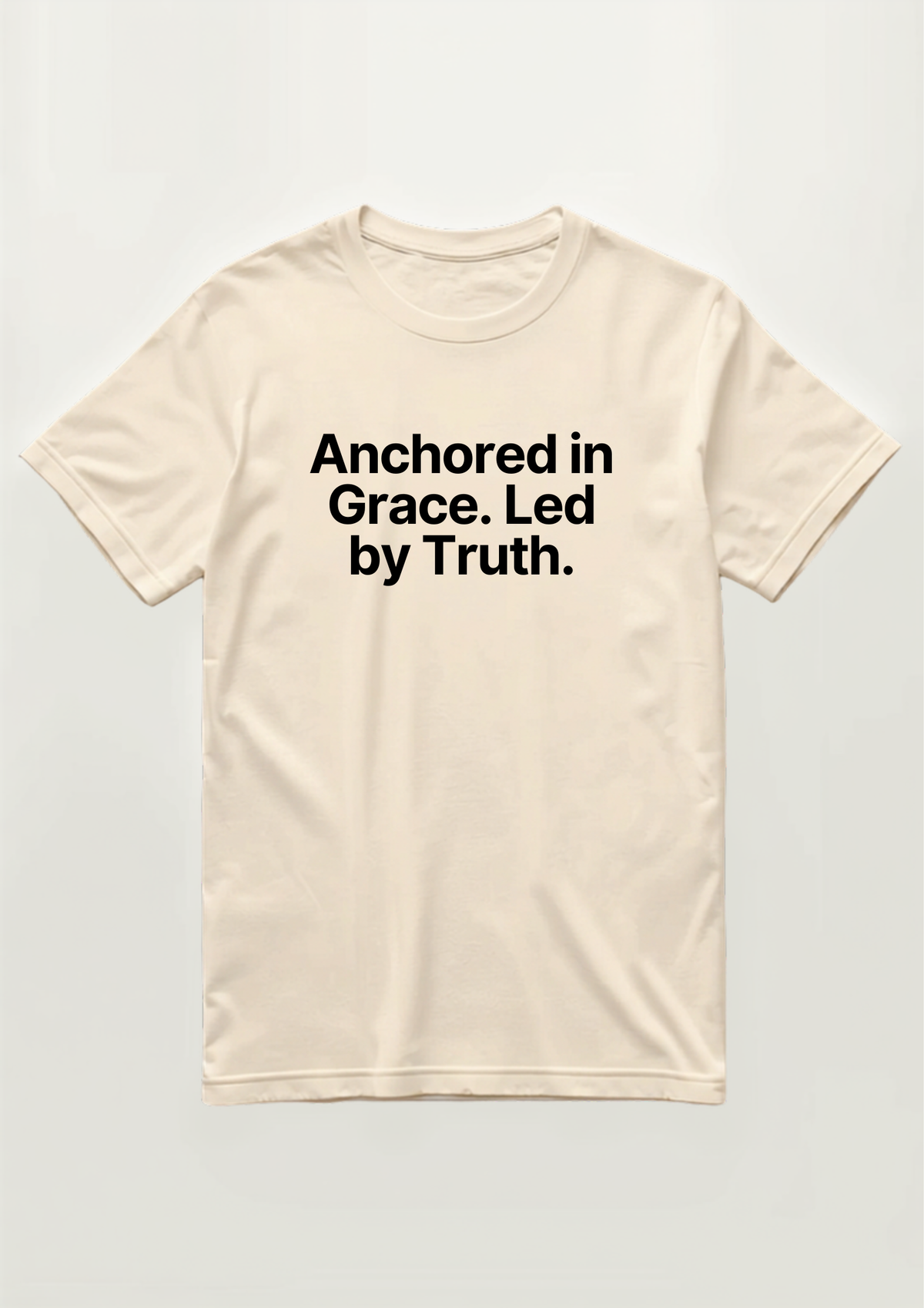 Anchored in Grace Tee in cream, flat lay, reading Anchored in Grace. Led by Truth. in black text
